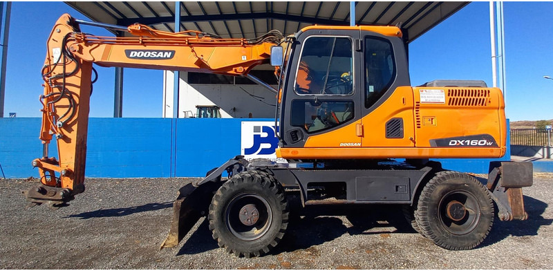 Doosan DX140W-3 - Ratinis ekskavatorius: foto 1 Doosan DX140W-3 - Ratinis ekskavatorius: foto 1