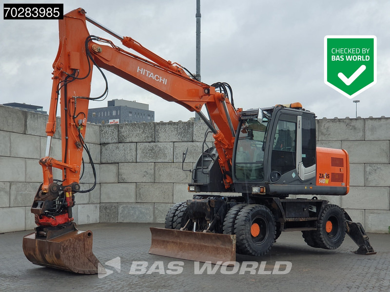 Hitachi ZX140W -3 OUTRIGGERS - ROTOTILT - Ratinis ekskavatorius: foto 1 Hitachi ZX140W -3 OUTRIGGERS - ROTOTILT - Ratinis ekskavatorius: foto 1