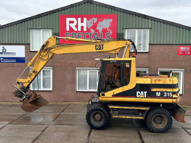 Caterpillar M315 +ROTO CE - Ratinis ekskavatorius: foto 1 Caterpillar M315 +ROTO CE - Ratinis ekskavatorius: foto 1