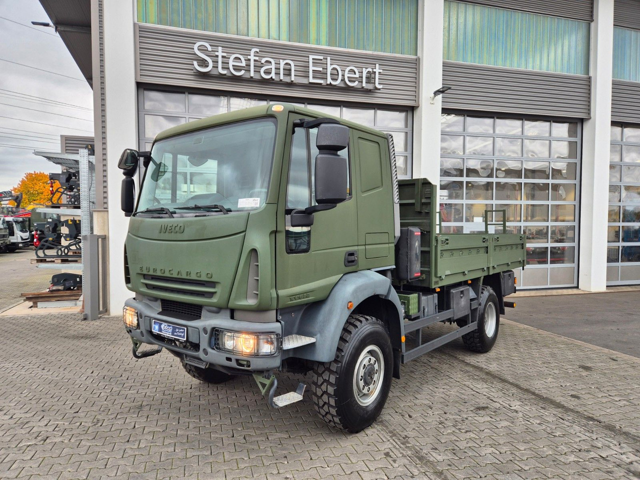 Iveco Eurocargo ML100E22WM-BW 4x4 Pritsche L-Haus Bett - Platforminis/ Bortinis sunkvežimis: foto 1 Iveco Eurocargo ML100E22WM-BW 4x4 Pritsche L-Haus Bett - Platforminis/ Bortinis sunkvežimis: foto 1